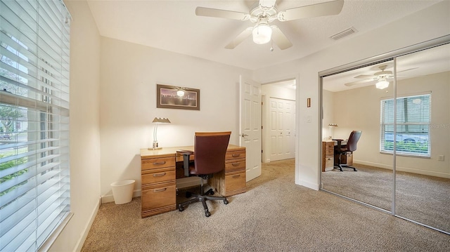 carpeted home office with ceiling fan