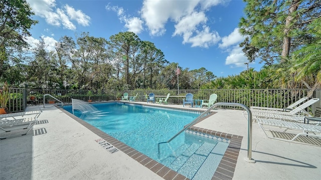 view of pool with a patio and pool water feature