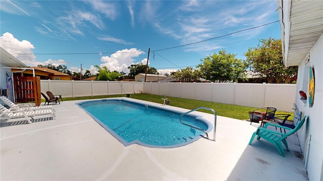 view of swimming pool with a patio