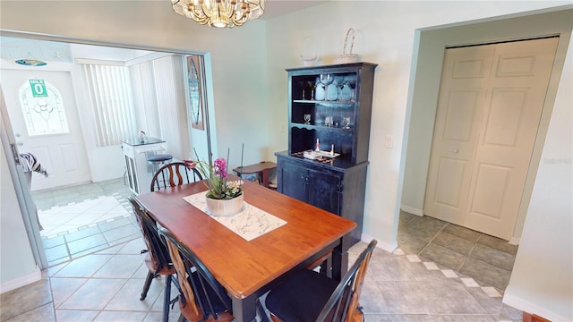 tiled dining space featuring a chandelier