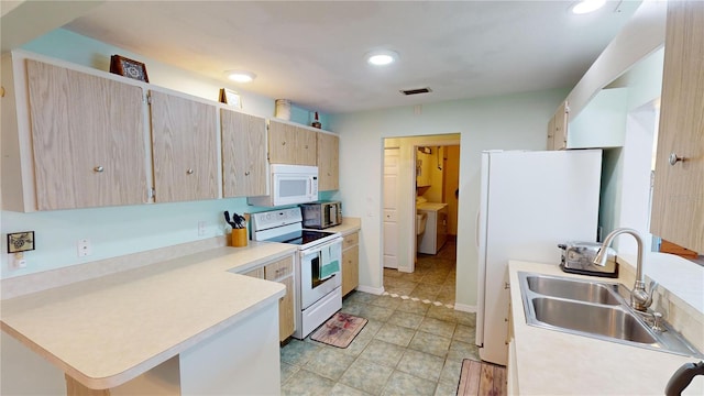 kitchen with kitchen peninsula, light brown cabinetry, white appliances, sink, and light tile patterned floors