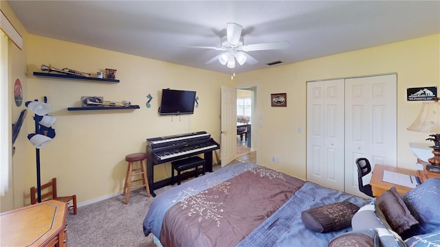 bedroom featuring a closet, ceiling fan, and light colored carpet