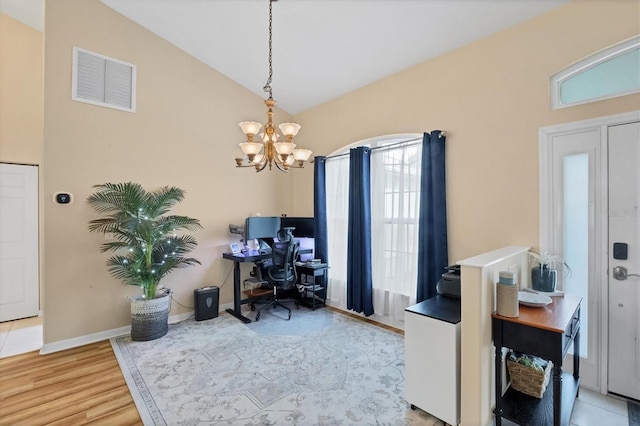 office featuring a chandelier, light hardwood / wood-style flooring, and lofted ceiling