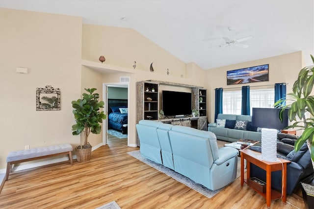 living room with light hardwood / wood-style floors, ceiling fan, and lofted ceiling