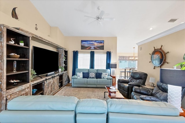 living room featuring ceiling fan with notable chandelier and lofted ceiling