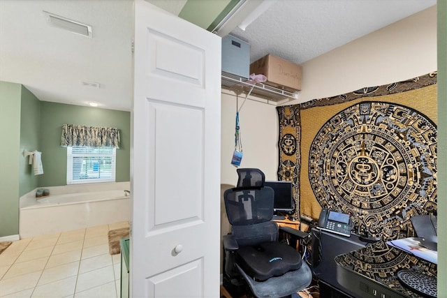 home office with a textured ceiling and tile patterned flooring