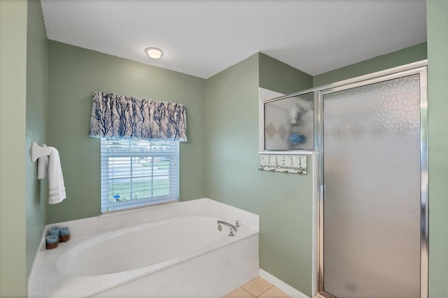 bathroom with independent shower and bath, tile patterned floors, and a textured ceiling