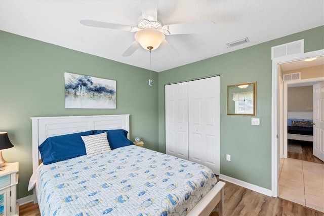 bedroom featuring a closet, wood-type flooring, and ceiling fan