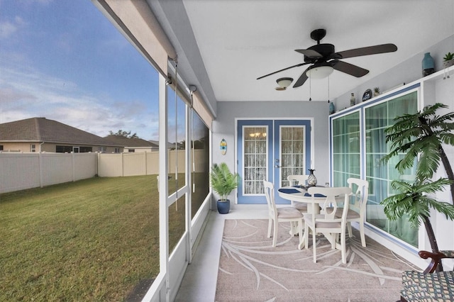 sunroom / solarium with french doors and ceiling fan