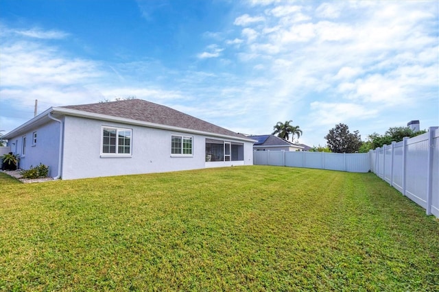 back of house featuring a lawn