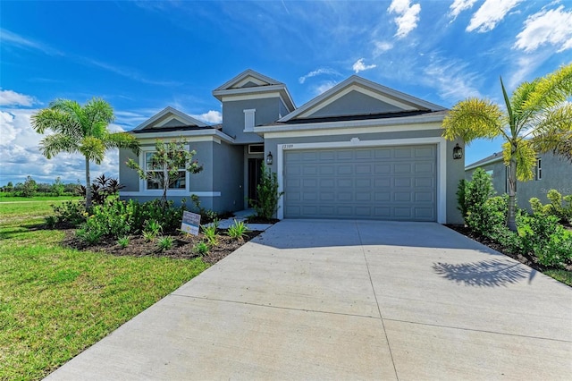 view of front of house featuring a garage and a front lawn