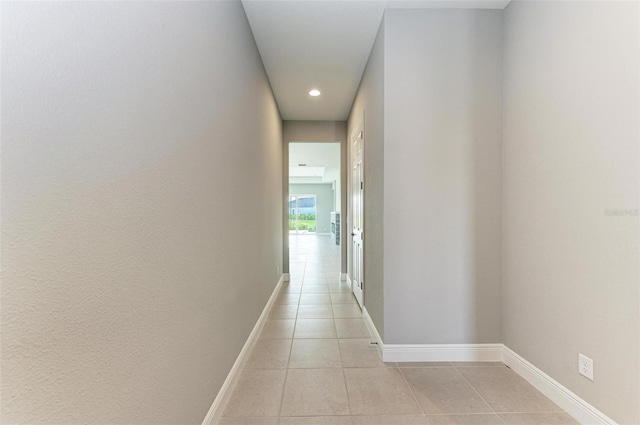 hall featuring light tile patterned floors