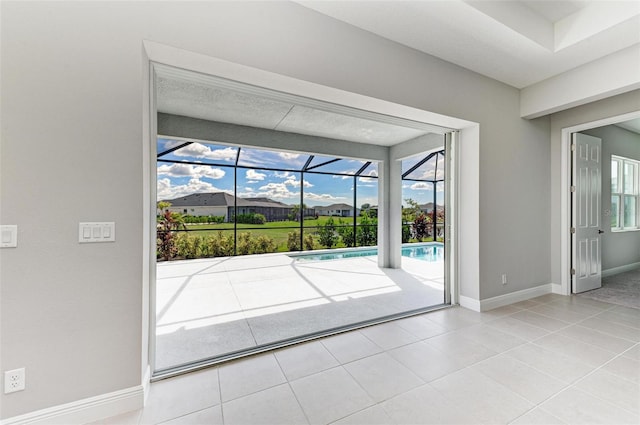 doorway to outside with light tile patterned floors