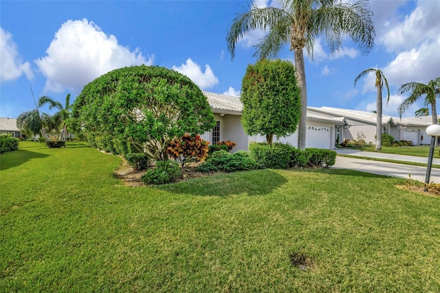 view of front of house with a garage and a front yard