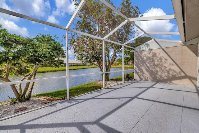 unfurnished sunroom featuring a water view