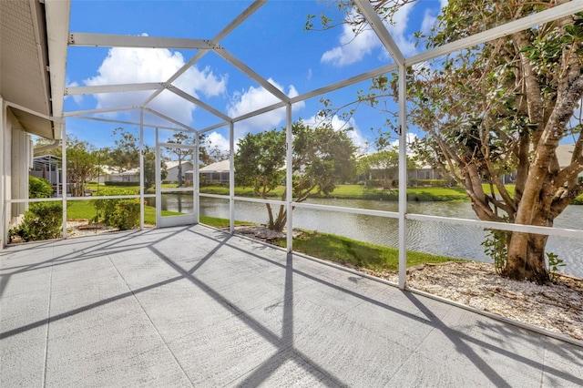 unfurnished sunroom featuring a water view and vaulted ceiling