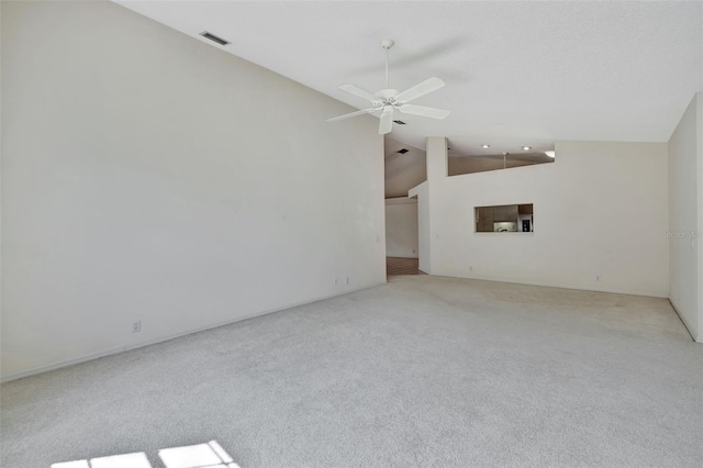 empty room with light colored carpet, high vaulted ceiling, and ceiling fan