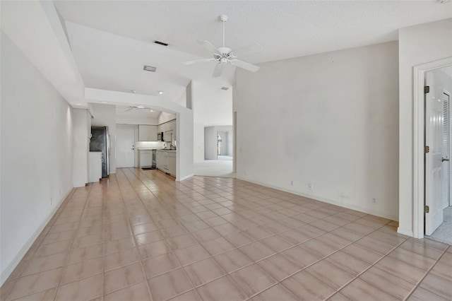 unfurnished living room featuring light tile patterned floors, a textured ceiling, and ceiling fan