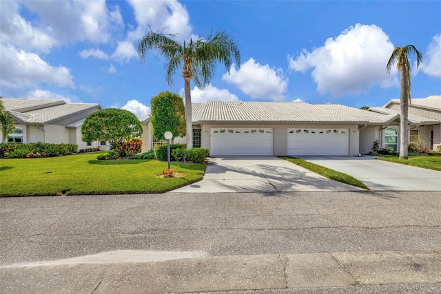 single story home featuring a garage and a front yard