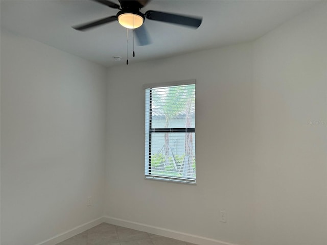 unfurnished room with light tile patterned floors and ceiling fan