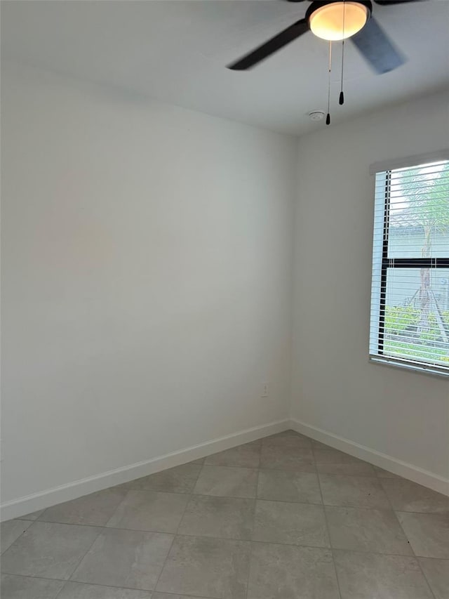 spare room featuring ceiling fan and light tile patterned flooring