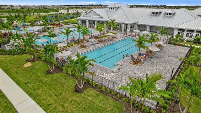 view of swimming pool featuring a lawn and a patio area