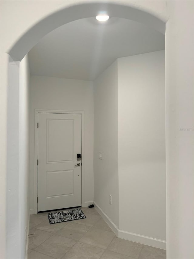 doorway to outside with light tile patterned flooring