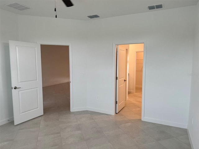 tiled empty room with ceiling fan