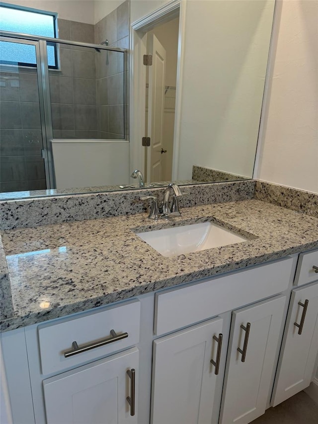 bathroom featuring vanity and an enclosed shower