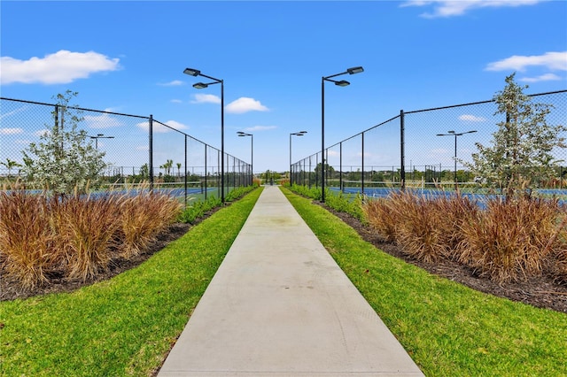 view of community featuring tennis court