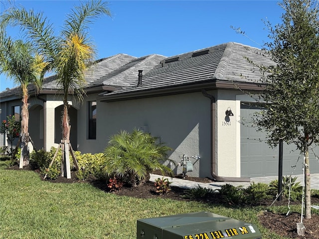 view of property exterior with a garage and a yard