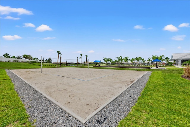 view of property's community featuring volleyball court and a lawn