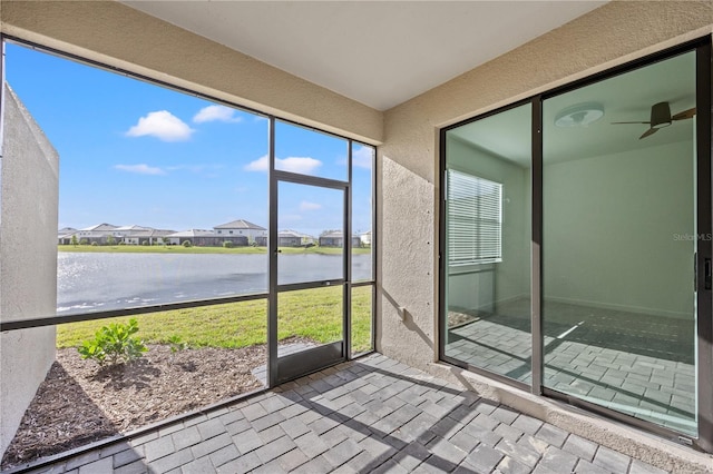 unfurnished sunroom featuring a water view