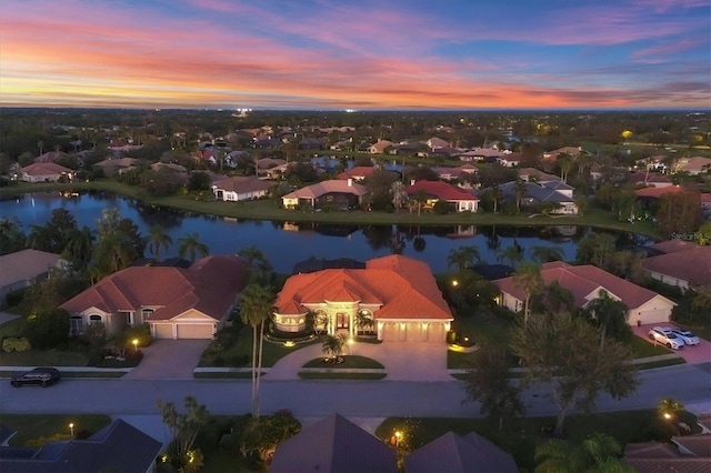 birds eye view of property featuring a residential view and a water view