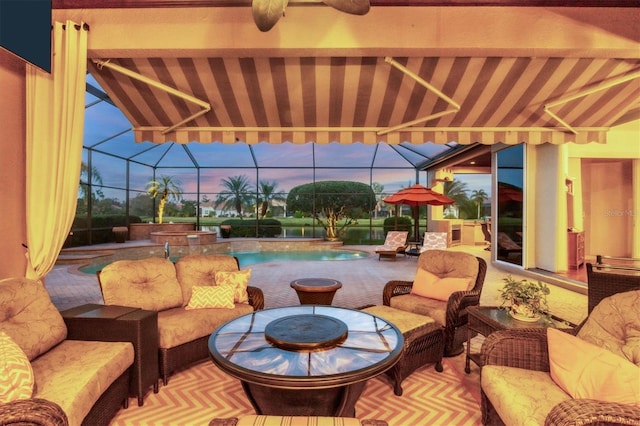 patio terrace at dusk featuring glass enclosure and outdoor lounge area