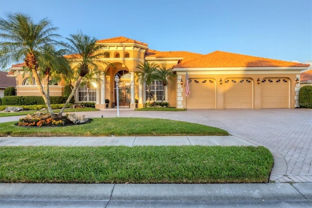 mediterranean / spanish house featuring a garage