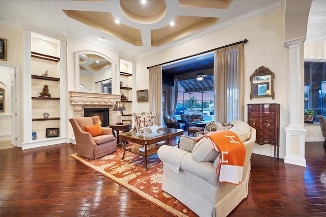 living room with dark wood-type flooring, crown molding, ornate columns, and built in shelves