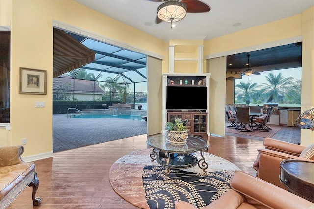 living room featuring wood-type flooring and ceiling fan