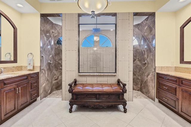 bathroom with vanity, tile walls, tile patterned floors, and tiled shower