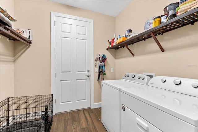 laundry area with dark hardwood / wood-style flooring and washer and dryer