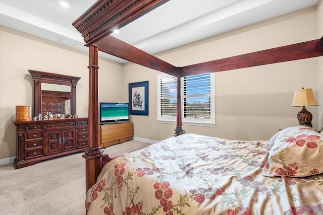 carpeted bedroom with beam ceiling