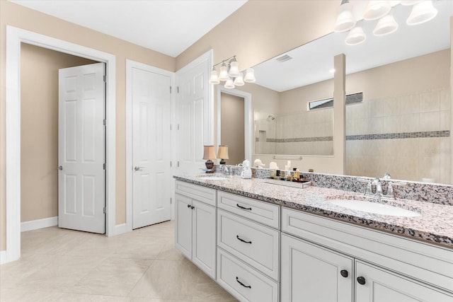 bathroom with vanity and a tile shower