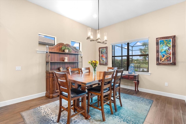 dining room featuring hardwood / wood-style floors and a notable chandelier