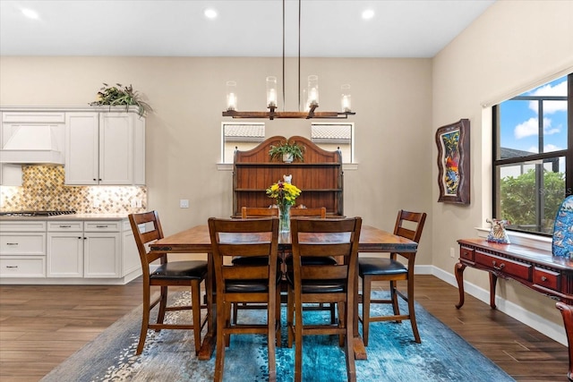 dining space with wood-type flooring and a chandelier