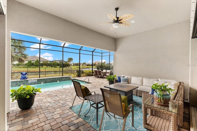 view of patio with an outdoor hangout area, a lanai, ceiling fan, and pool water feature