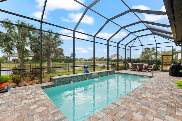 view of pool with a lanai, a grill, pool water feature, and a patio area