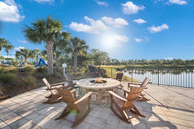 view of patio / terrace with a water view and a fire pit