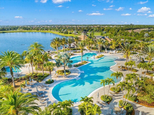 view of swimming pool featuring a water view and a patio area