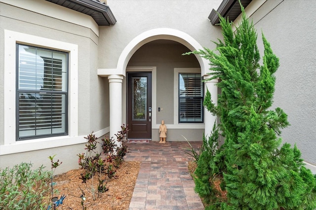 view of exterior entry with stucco siding