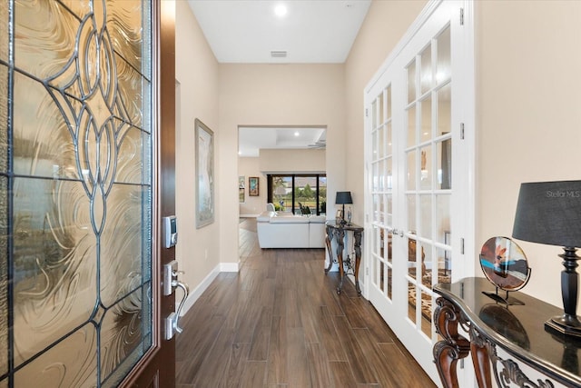 foyer entrance with french doors, baseboards, visible vents, and dark wood-style floors
